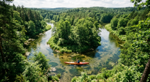 A high-angle, editorial-style photograph of a colorful kayak gliding peacefully down the winding, cr